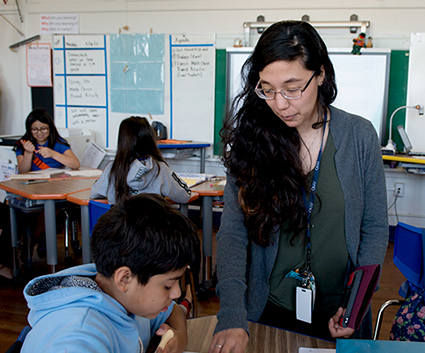 Student helping child in the classroom