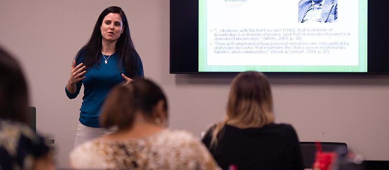 Female professor lectures in front of class