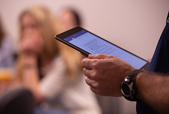 Male holding tablet in hand