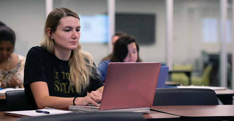 Female on laptop in class